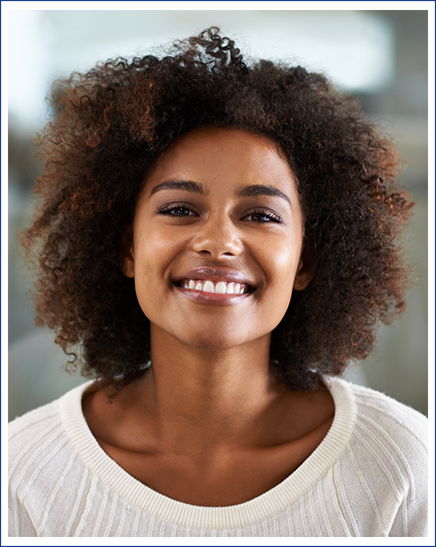 a patient smiling while visiting her dentist