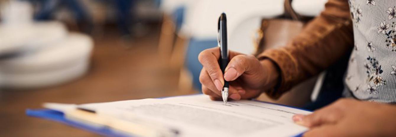 Woman sitting in a cozy chair and holding a piggy bank