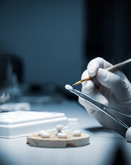a dental lab technician crafting a custom crown