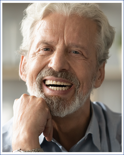 Confident, smiling senior man in blue sweater