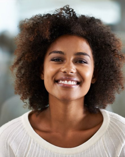 a woman smiling with bright teeth