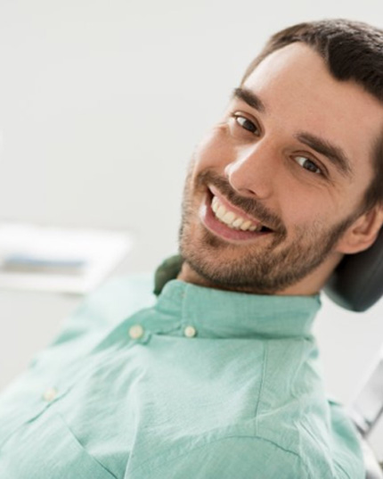 a patient smiling while visiting the dentist