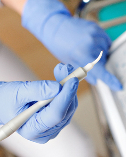 Dentist holding dental laser 