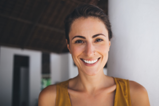 Smiling woman in sleeveless green blouse