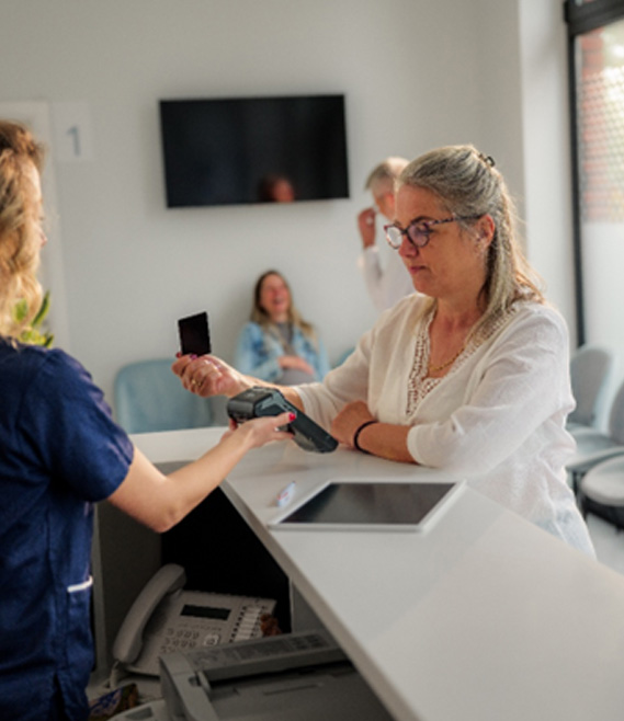 a patient paying for dental treatment