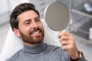 Man smiling into mirror